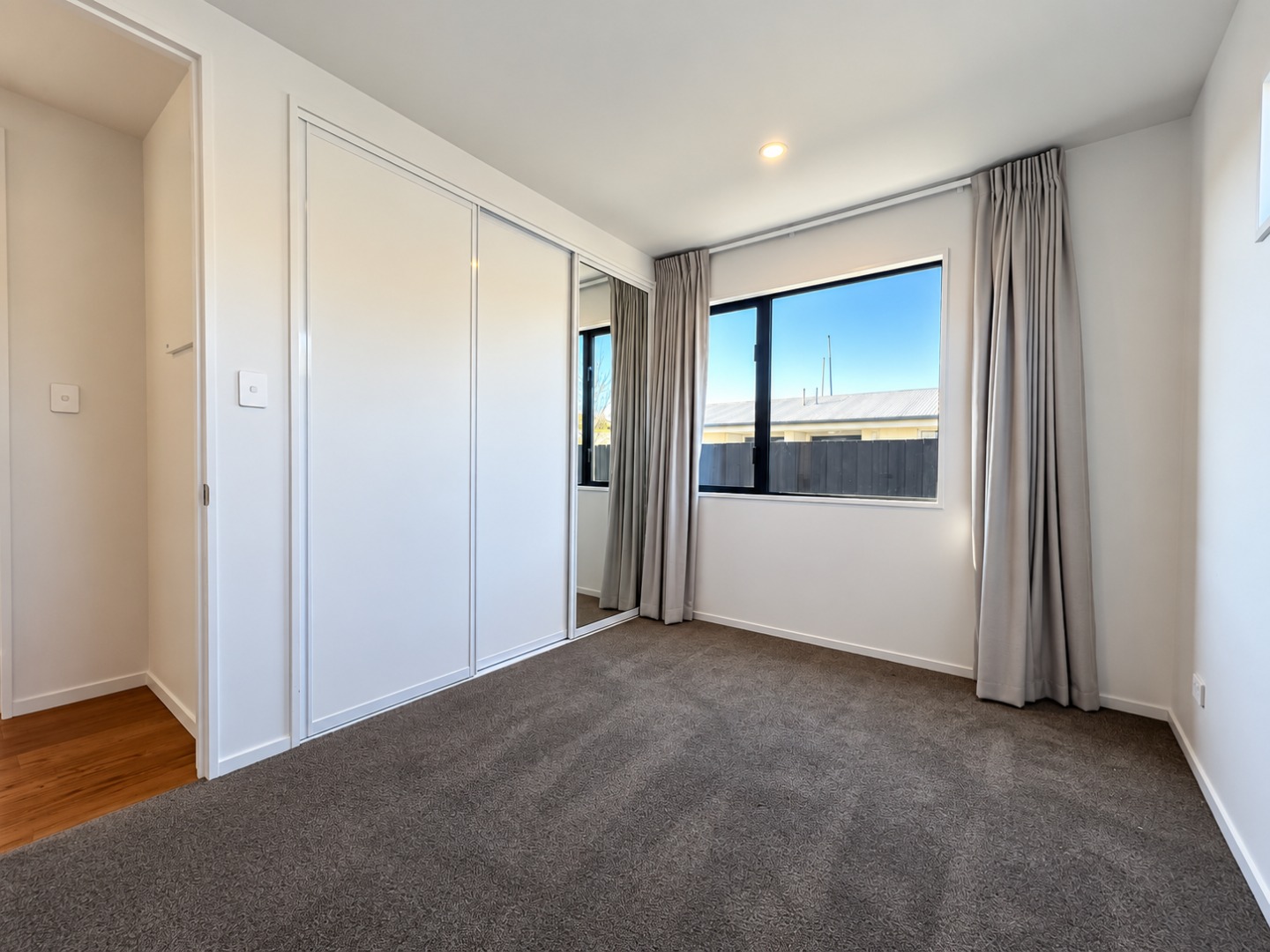 Bright Minimalist Room with Mirrored Wardrobe