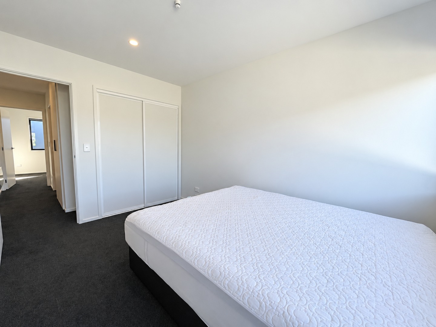 Bright Minimalist Bedroom with Quilted Mattress