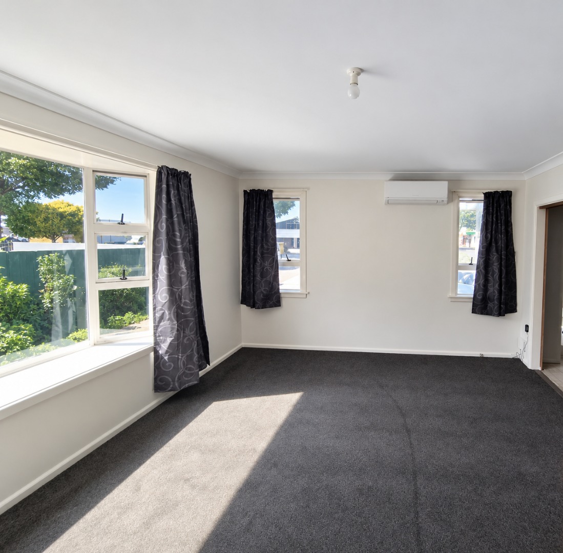 Sunlit Empty Living Room with Charcoal Carpet