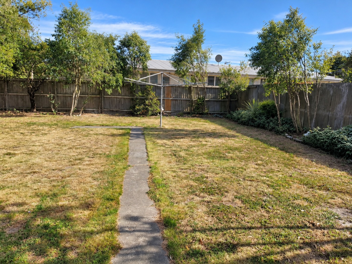 Sunny Suburban Backyard with Rotary Clothesline