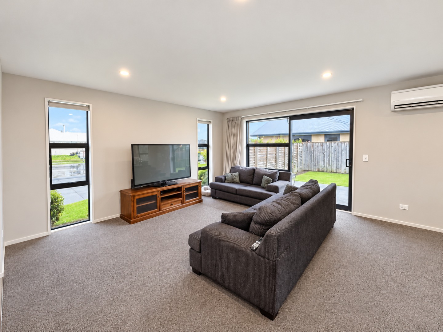 Bright Minimalist Living Room with Charcoal Sofas