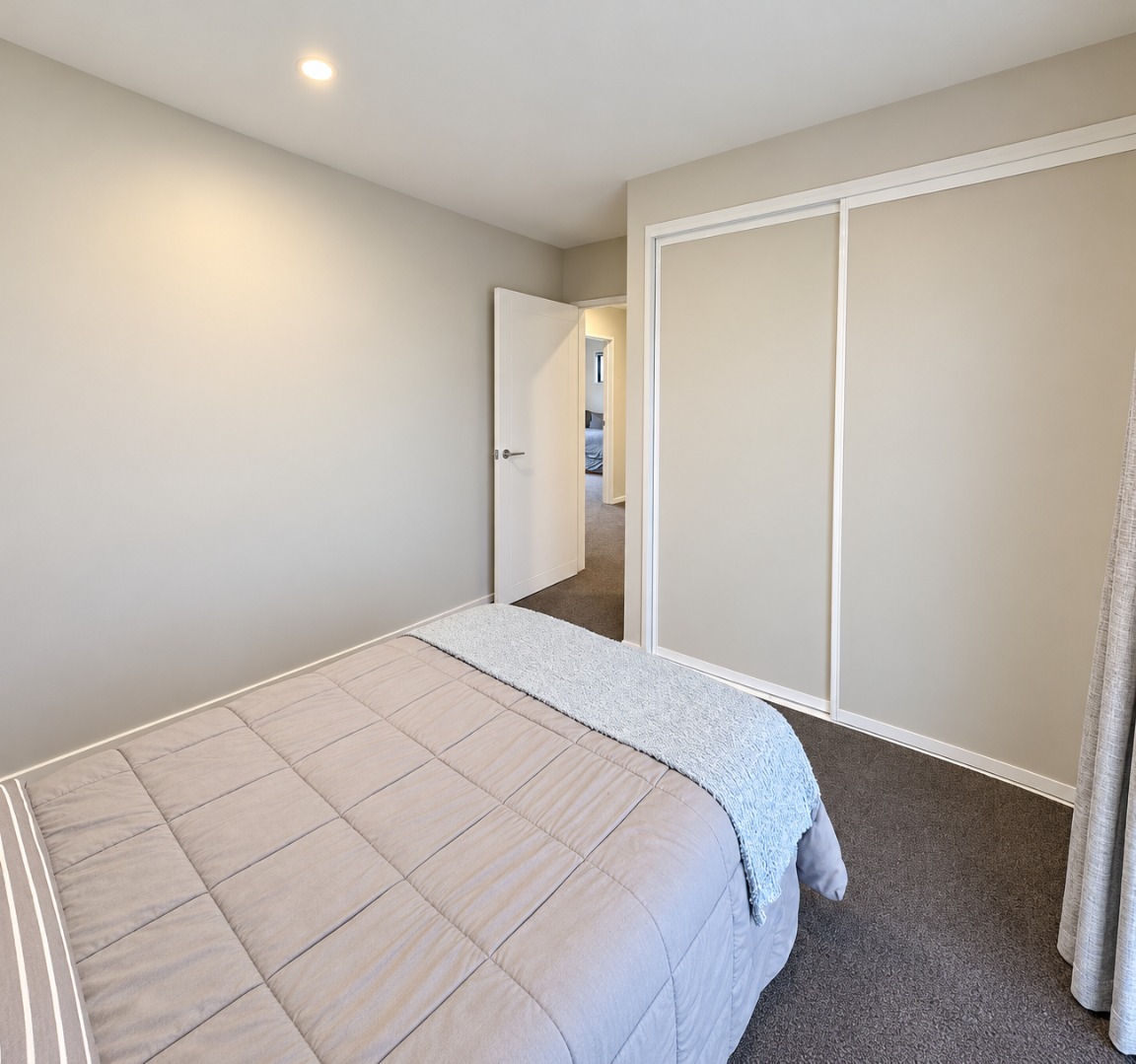 Bright Minimalist Bedroom with Built-In Wardrobe
