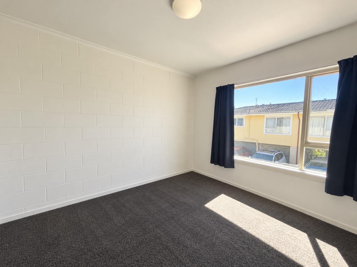 Bright Empty Bedroom with Sunlit Carpet