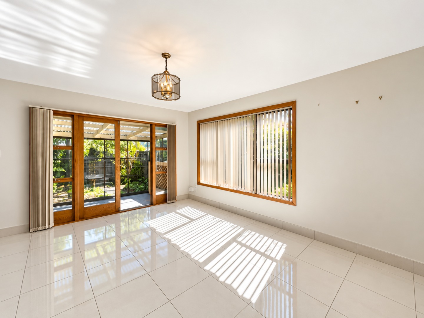 Sunlit Empty Living Room with Garden Views