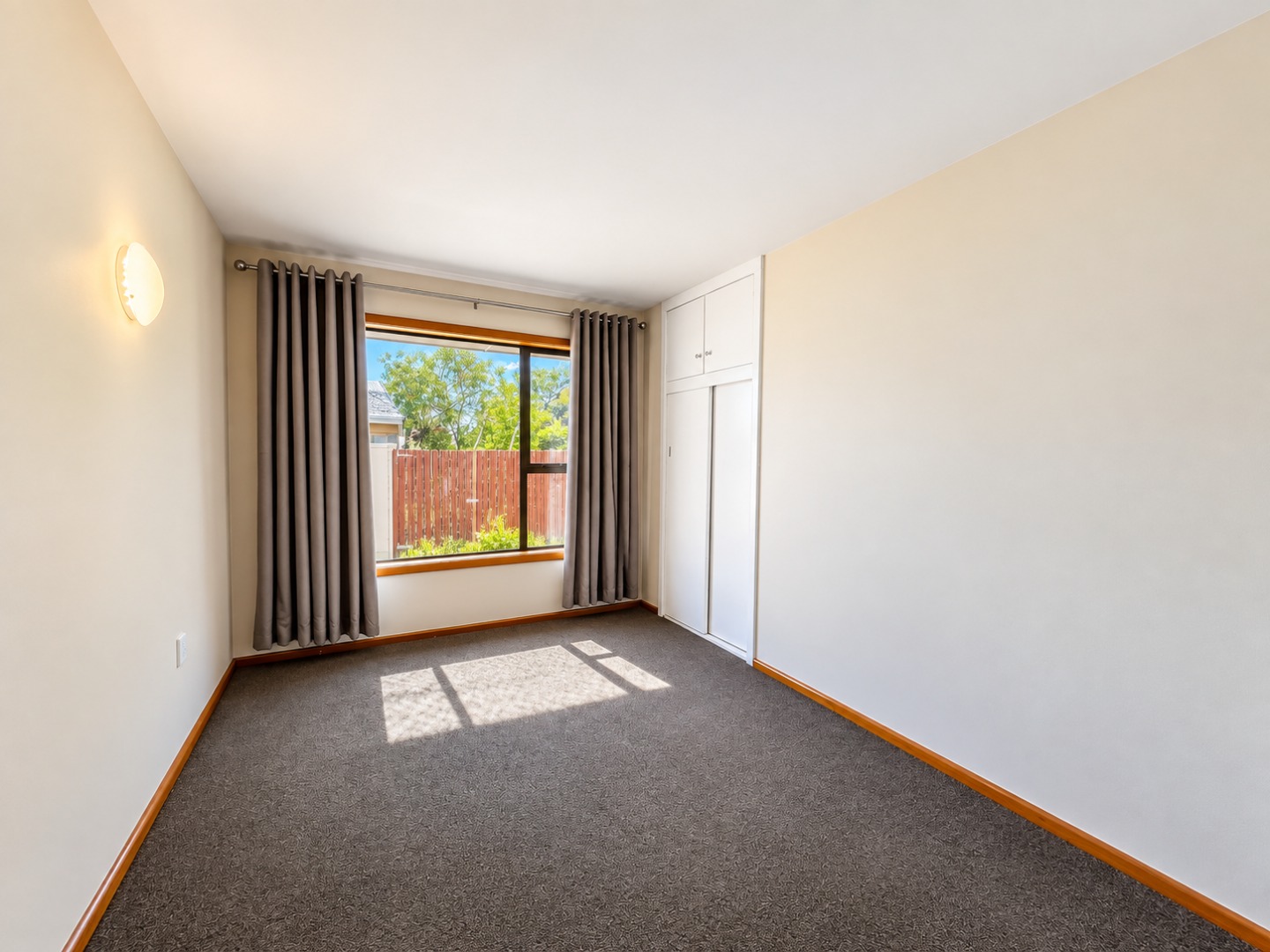 Bright Minimalist Bedroom with Window and Built-Ins