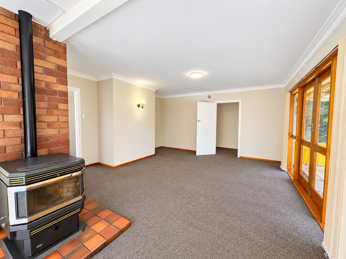 Bright Empty Living Room with Wood Stove