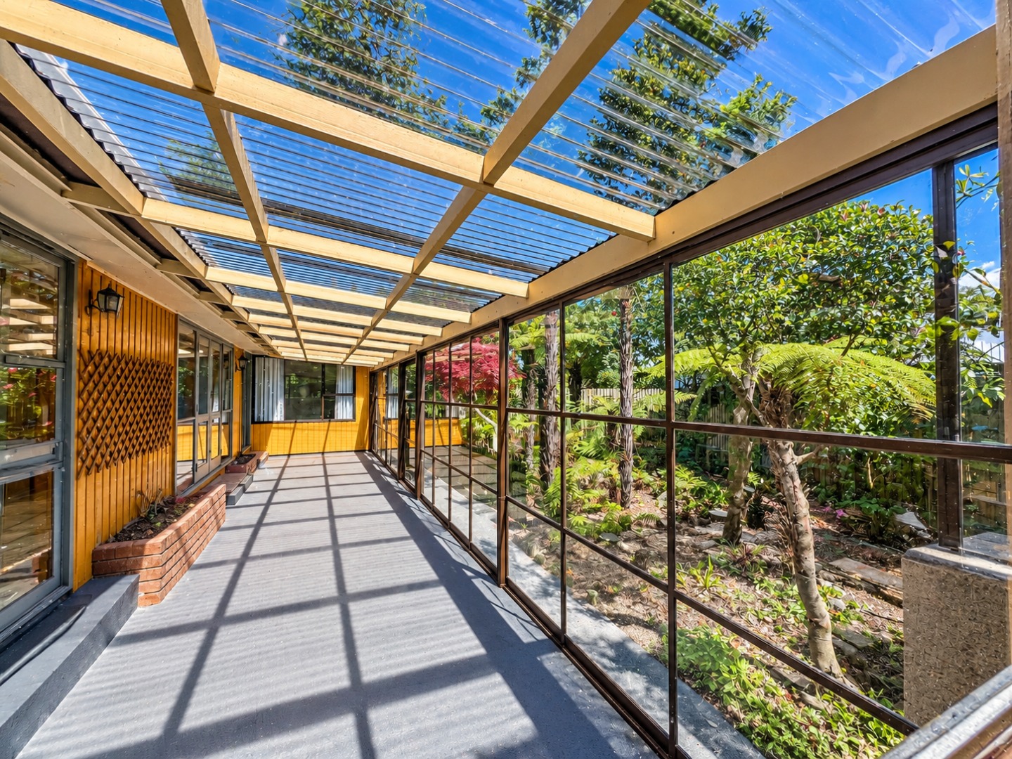 Sunlit Glass Veranda Overlooking a Lush Garden