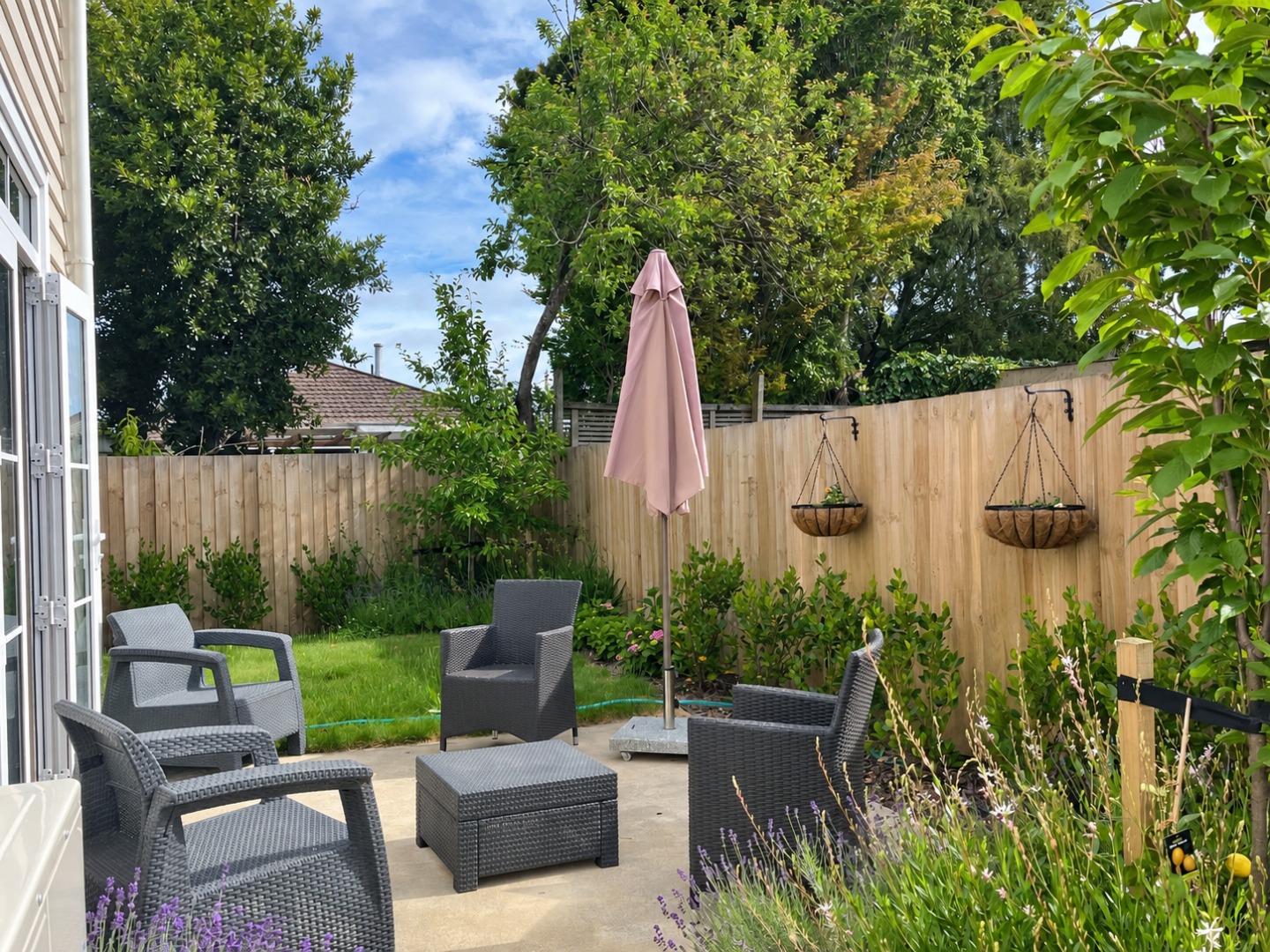 Sunlit Courtyard with Pale Pink Umbrella