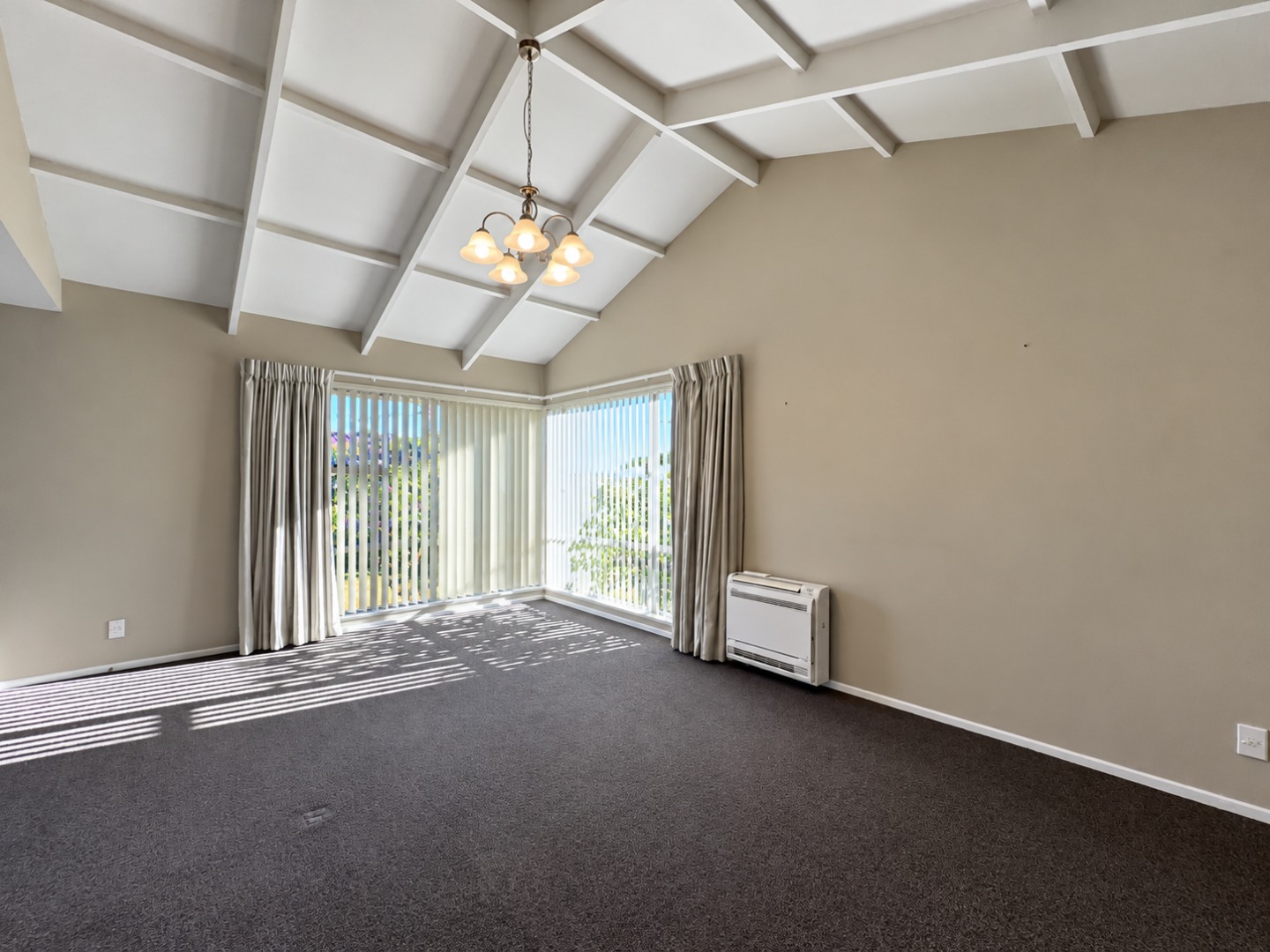 Sunlit Empty Room with Vaulted Ceiling