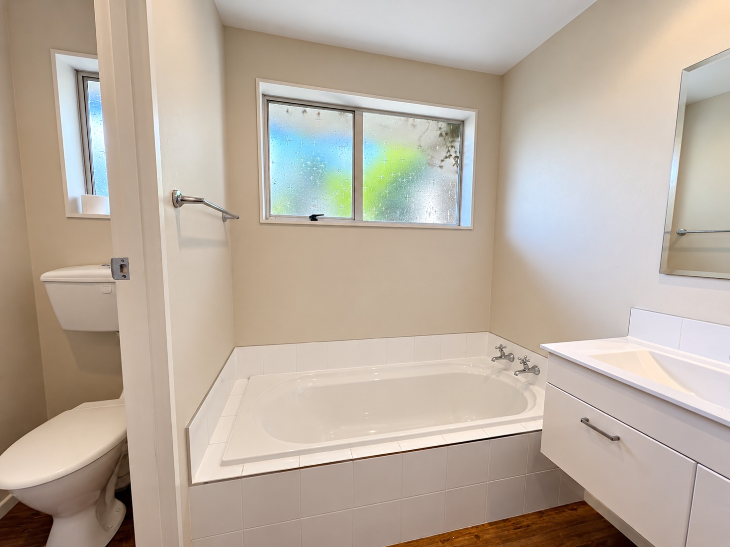 Bright Minimalist Bathroom with Frosted Window