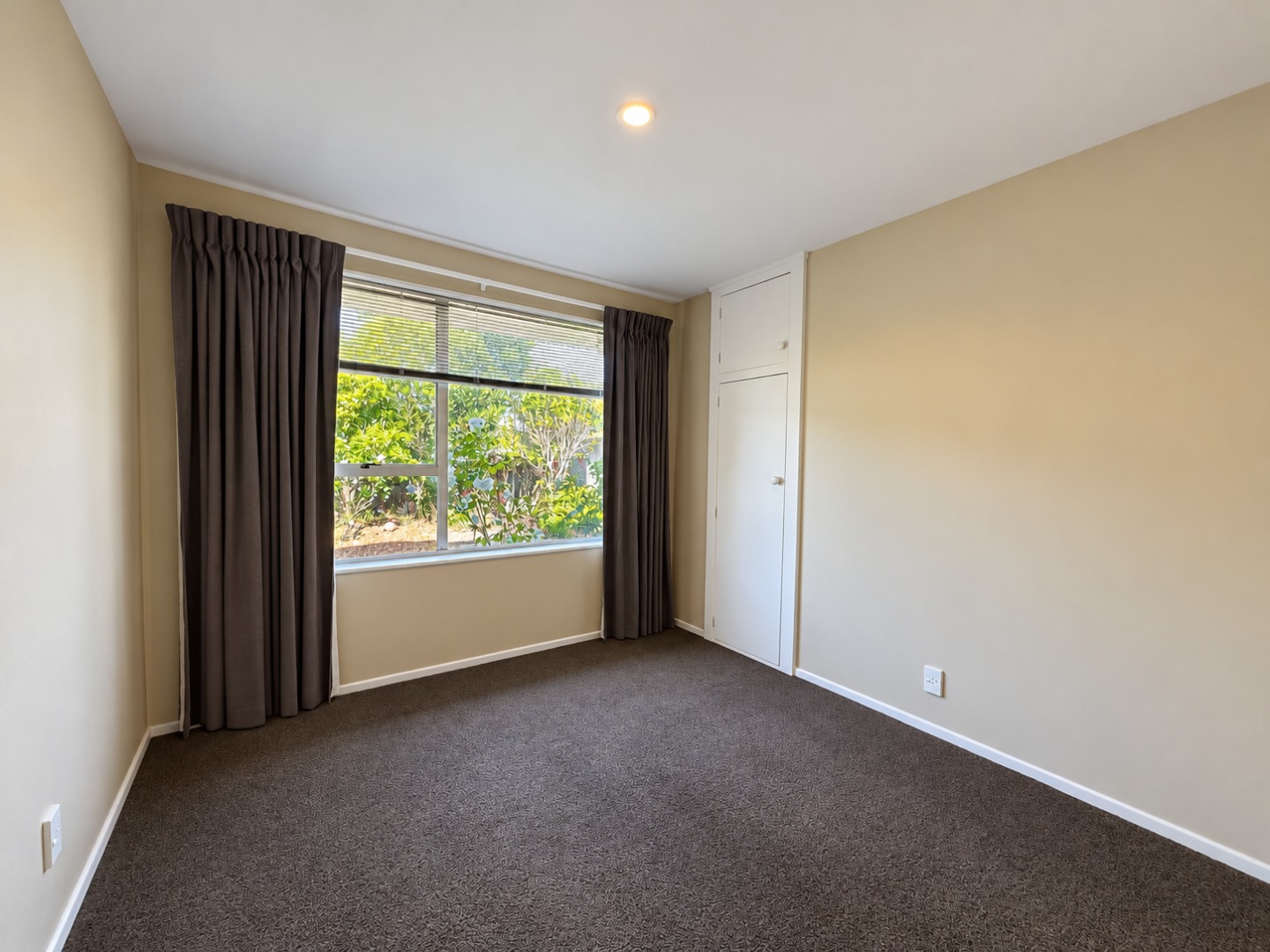 Empty Beige Bedroom with Garden Window